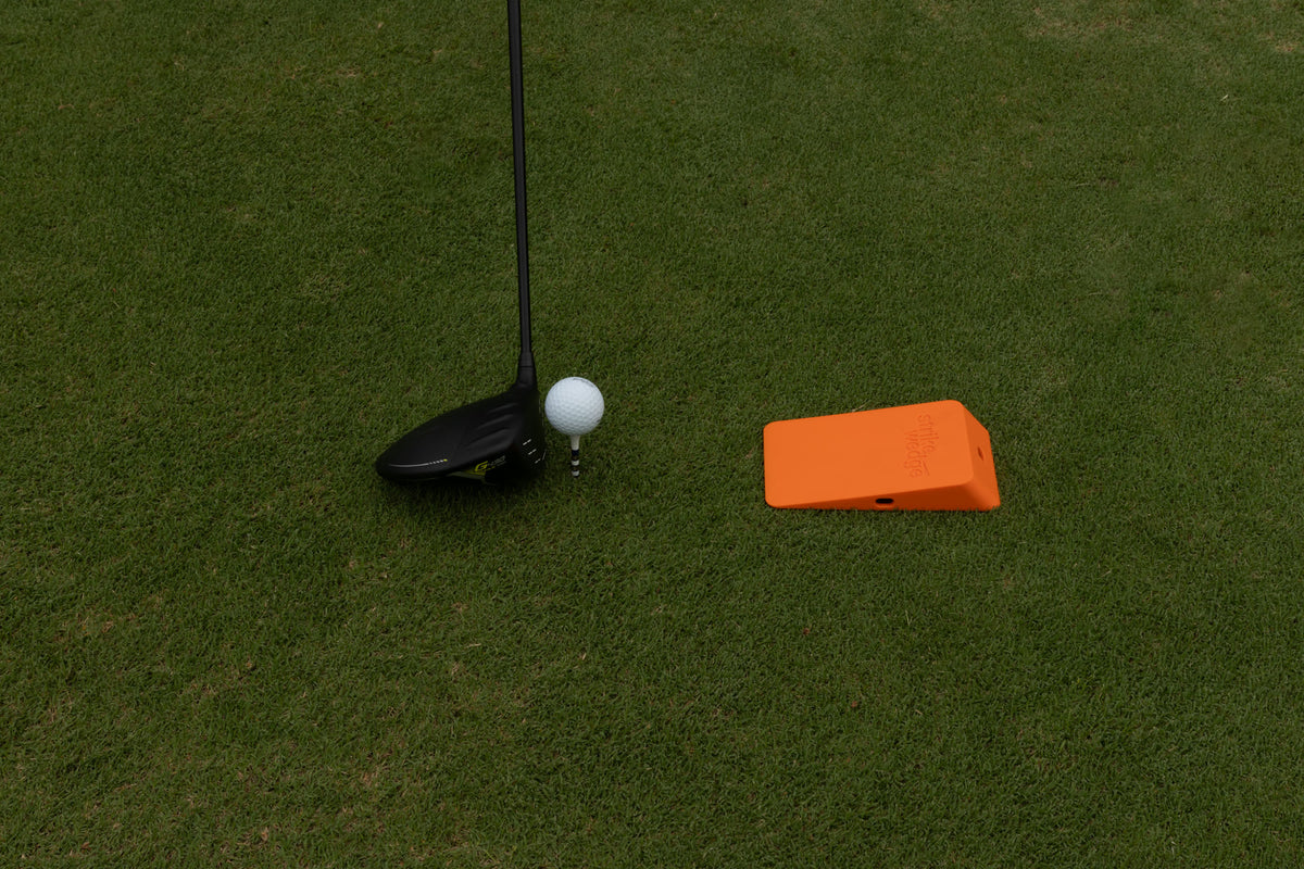 Strike Wedge set up for the driver: in front of the teed ball.