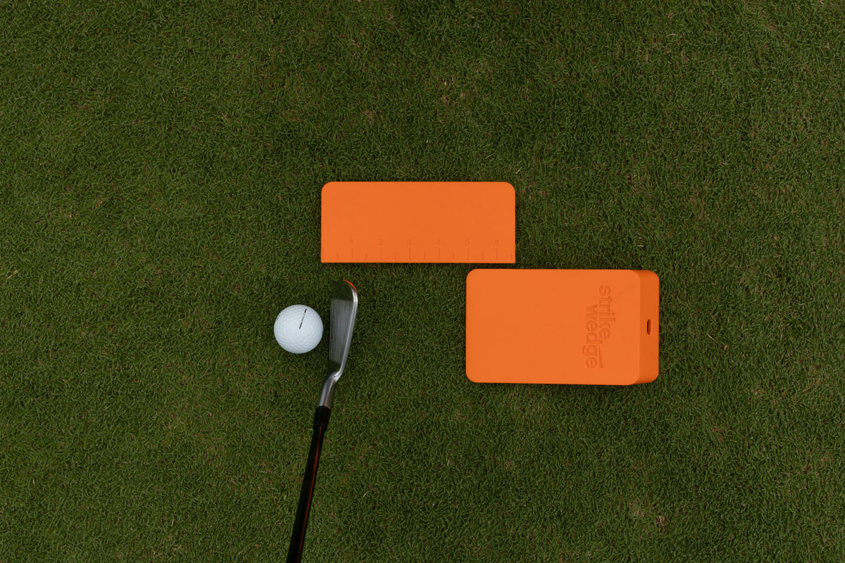 Strike Wedge set up for fat shots: behind the ball, with the wall attachment/ruler beside it showing the distance.