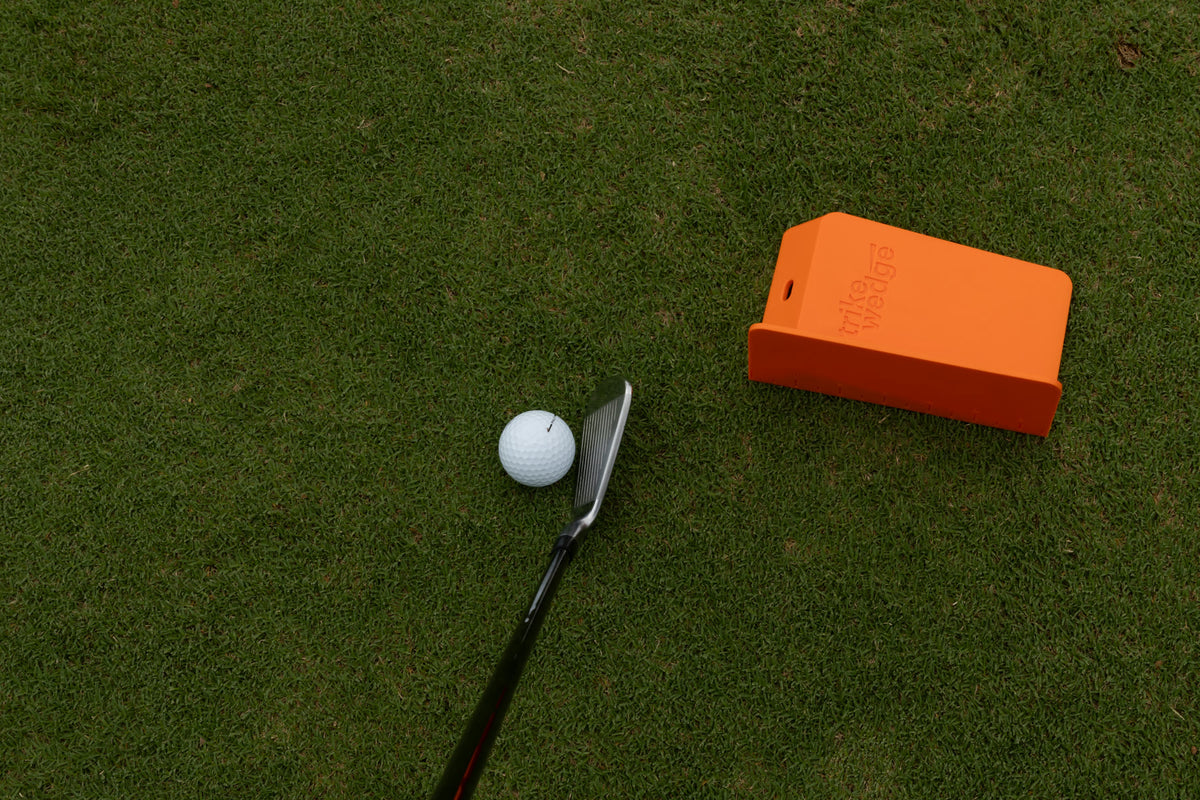 Strike Wedge set up for a slice: behind the ball on the outside, angled slightly right.